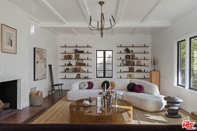 living room with dark hardwood / wood-style floors, beamed ceiling, a fireplace, and a wealth of natural light