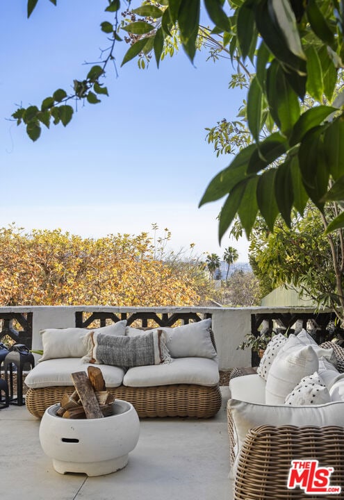 balcony featuring an outdoor living space and a patio area