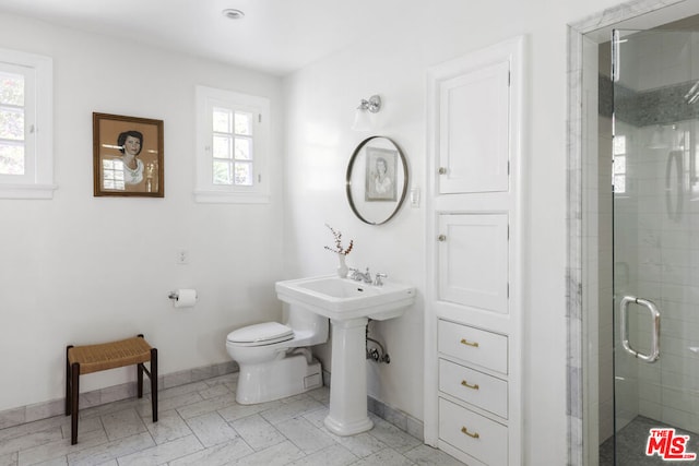 bathroom featuring an enclosed shower and toilet