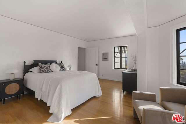 bedroom featuring light hardwood / wood-style floors and multiple windows