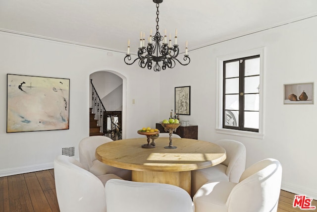 dining space featuring a chandelier and dark hardwood / wood-style flooring