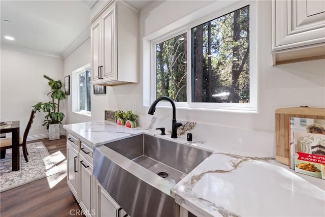 370 Auburn Dr, Lake Arrowhead, CA 92352 - kitchen with plenty of natural light, dark wood finished floors, light stone counters, ornamental molding, and white cabinetry