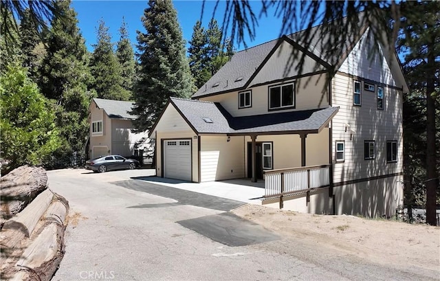 370 Auburn Dr, Lake Arrowhead, CA 92352 - view of front of home with a garage, a shingled roof, a porch, and asphalt driveway