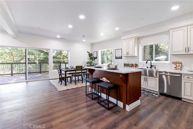 kitchen featuring a kitchen island, dishwasher, sink, a breakfast bar area, and dark wood-type flooring