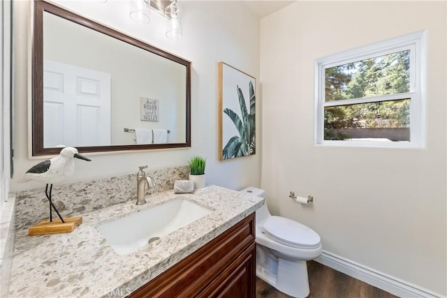 bathroom featuring vanity, hardwood / wood-style floors, and toilet