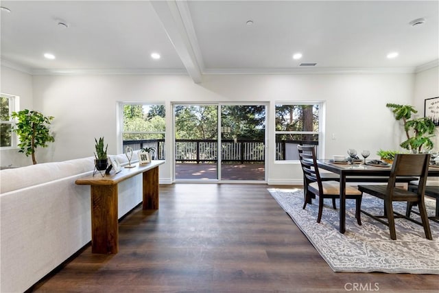 dining room with dark wood-type flooring, crown molding, and beamed ceiling