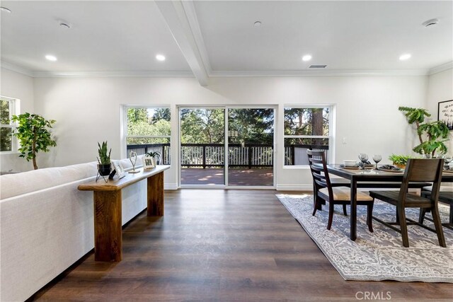 dining space featuring ornamental molding and dark hardwood / wood-style flooring