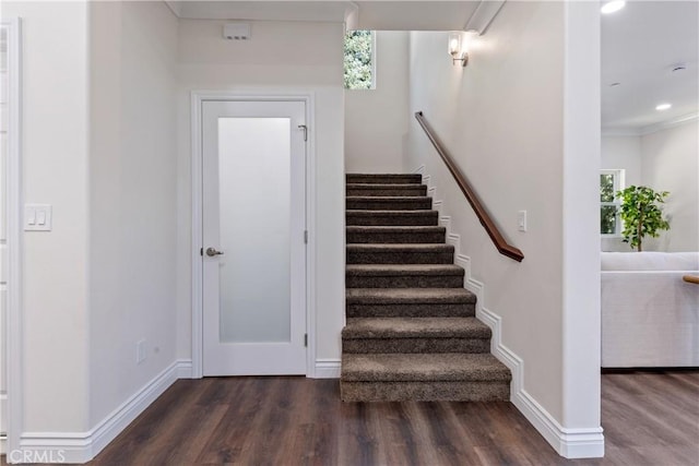 stairway featuring wood-type flooring and ornamental molding