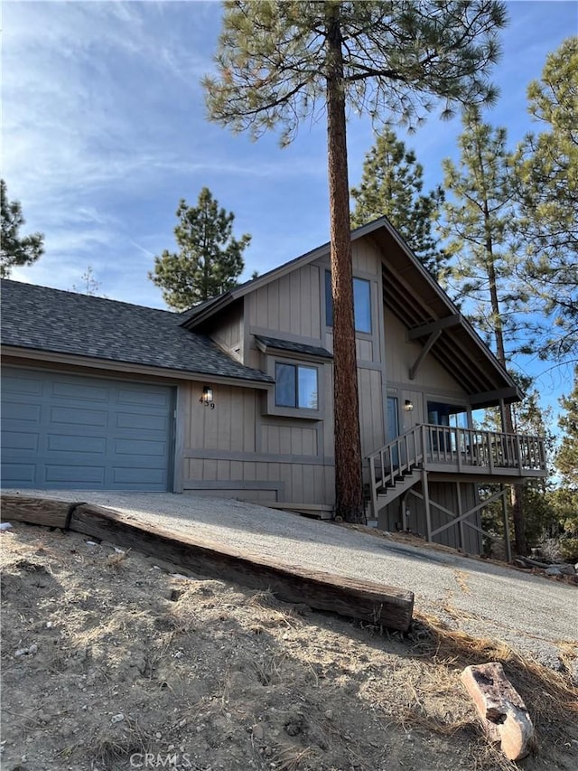 view of side of property with a garage and a deck