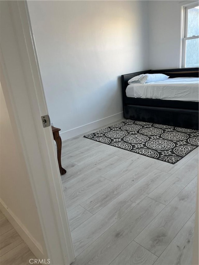 bedroom with light hardwood / wood-style floors