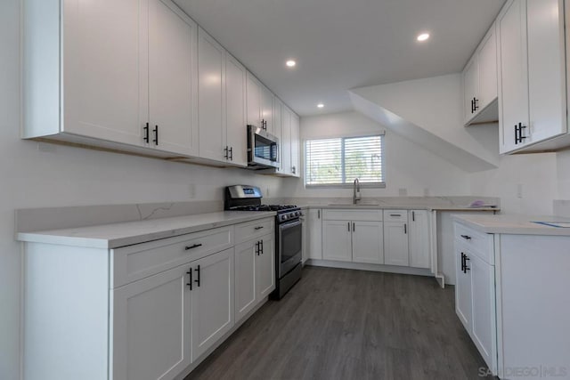 kitchen featuring stainless steel appliances, light hardwood / wood-style floors, sink, and white cabinets