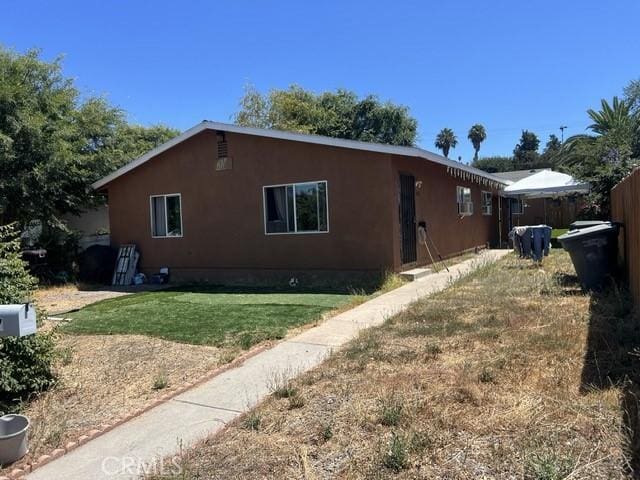 view of property exterior with a lawn