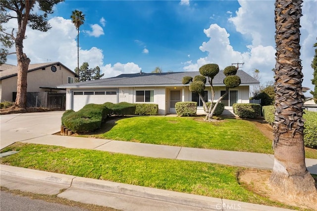 view of front of property with a garage and a front lawn