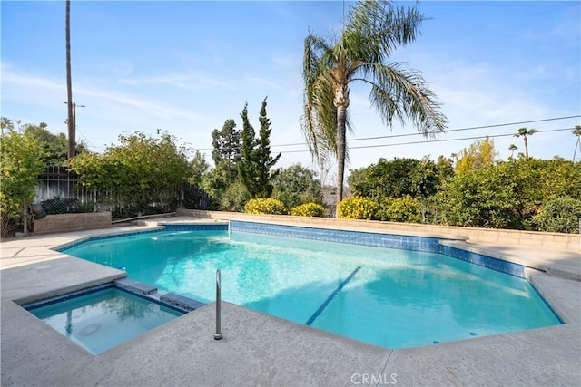 view of pool with an in ground hot tub