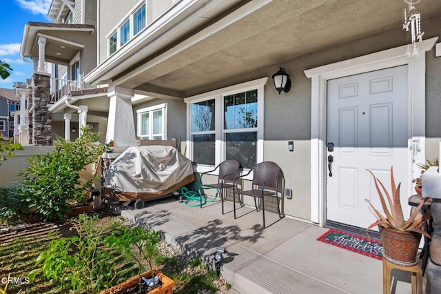 view of exterior entry featuring a patio