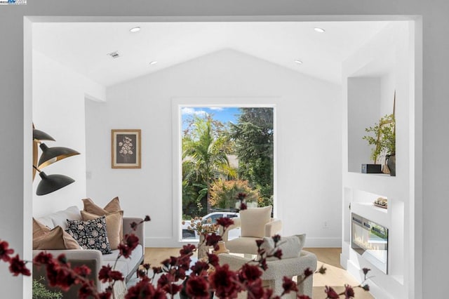 sitting room with vaulted ceiling and light hardwood / wood-style flooring