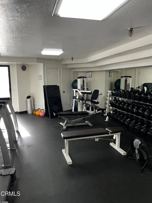 gym with a textured ceiling