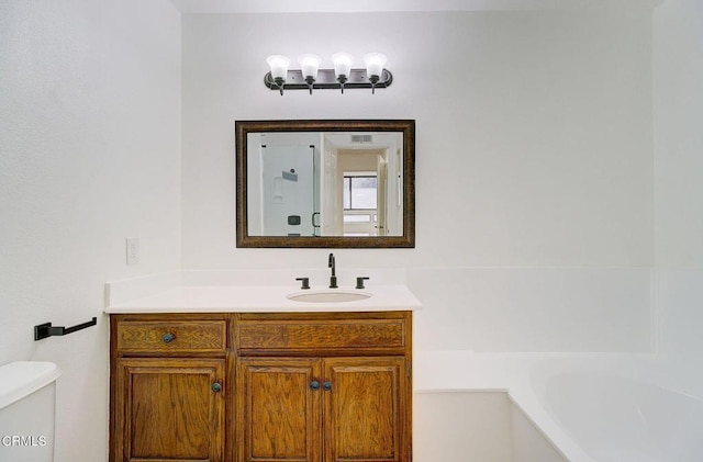 full bathroom featuring vanity, toilet, and separate shower and tub