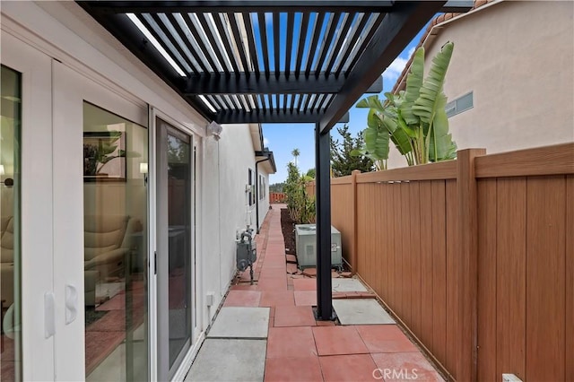 view of patio / terrace with cooling unit and a pergola