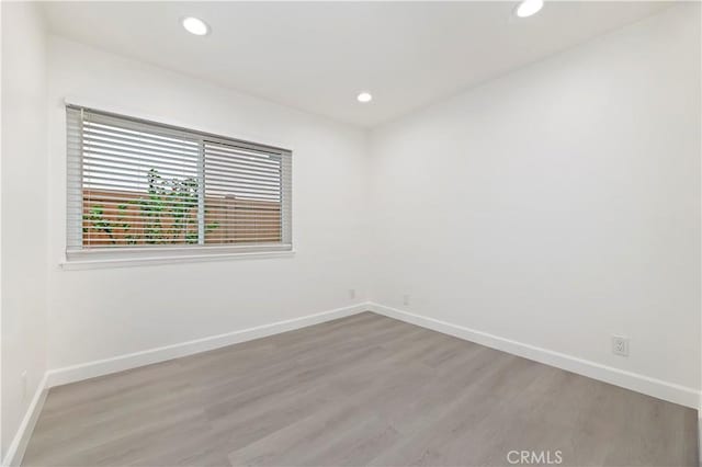 spare room with light wood-type flooring