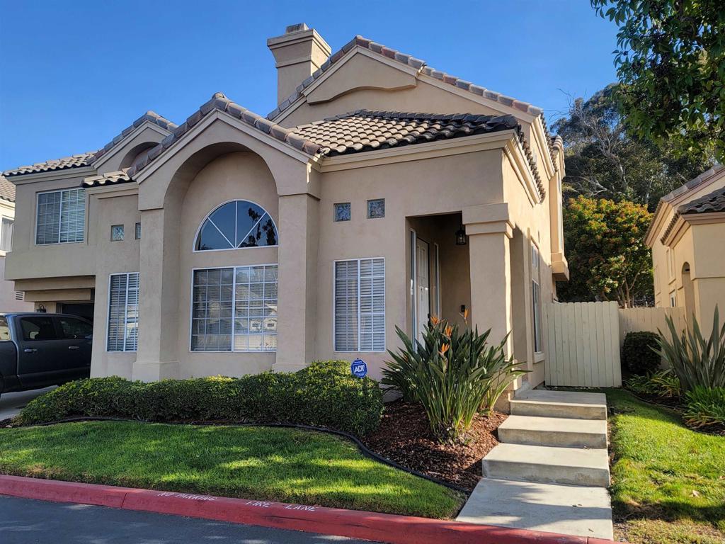 mediterranean / spanish-style house with a front lawn