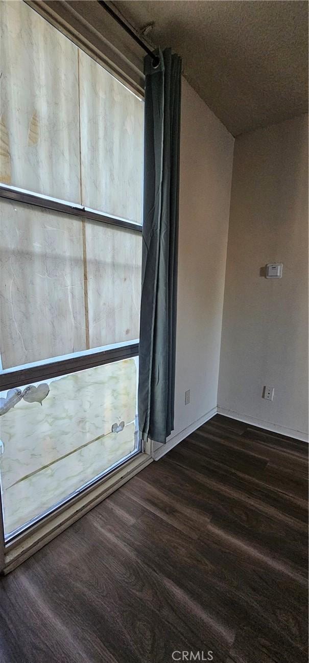 unfurnished room featuring dark hardwood / wood-style floors