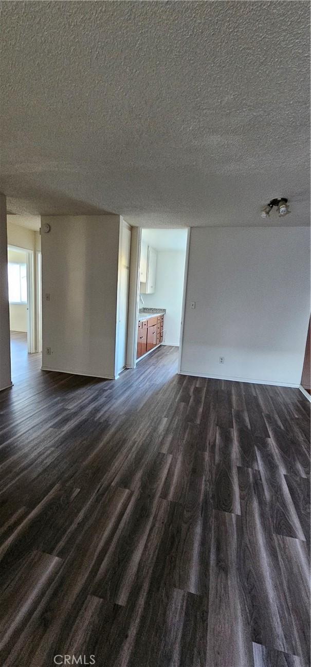 unfurnished living room featuring a textured ceiling