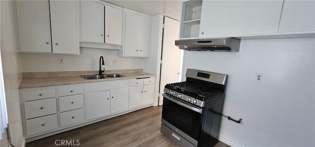 kitchen featuring gas range, dark hardwood / wood-style floors, sink, and white cabinets