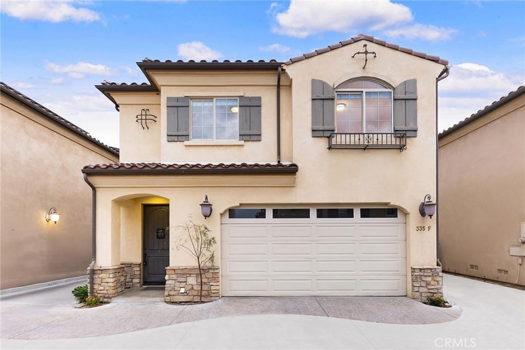 mediterranean / spanish house with a garage