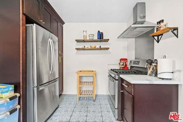 kitchen featuring appliances with stainless steel finishes, dark brown cabinets, and wall chimney range hood