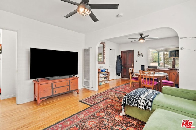 living room featuring wood-type flooring and ceiling fan