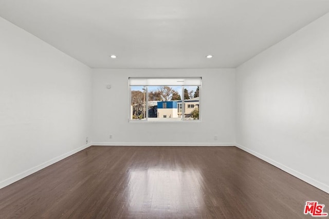 unfurnished room with dark hardwood / wood-style floors