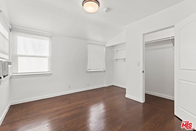 unfurnished bedroom featuring lofted ceiling and dark hardwood / wood-style floors