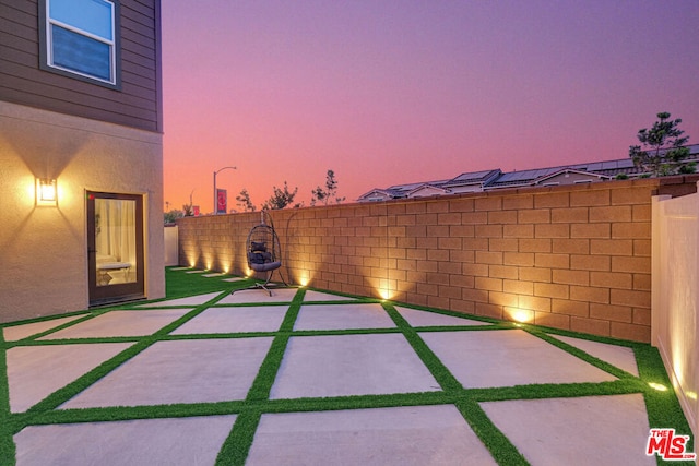 view of patio terrace at dusk