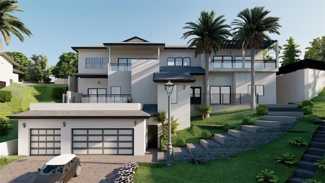 back of house with a garage, a balcony, and a yard