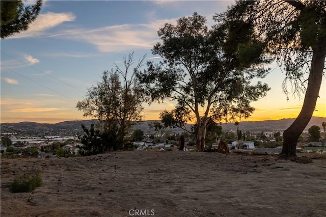 yard at dusk featuring a mountain view