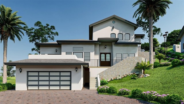 view of front of property with french doors, a garage, and a front lawn