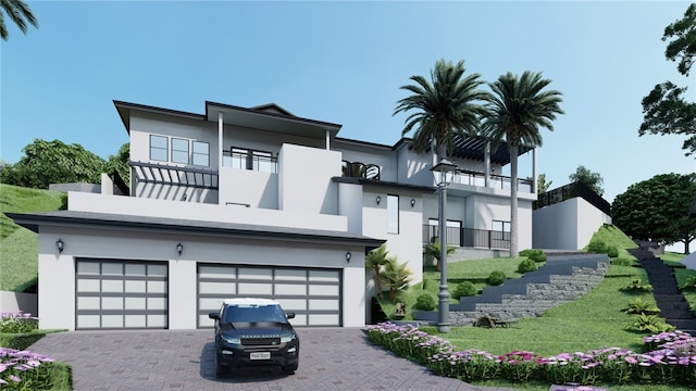 view of front of house with a garage, a balcony, and a front yard