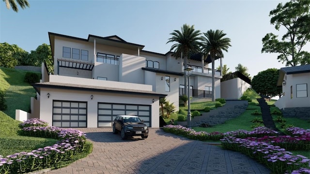 rear view of house with a balcony and a garage