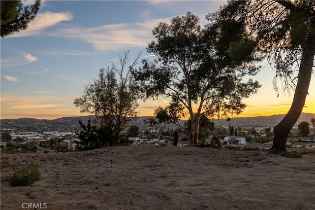 yard at dusk featuring a mountain view