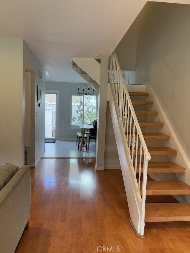 stairway with hardwood / wood-style flooring