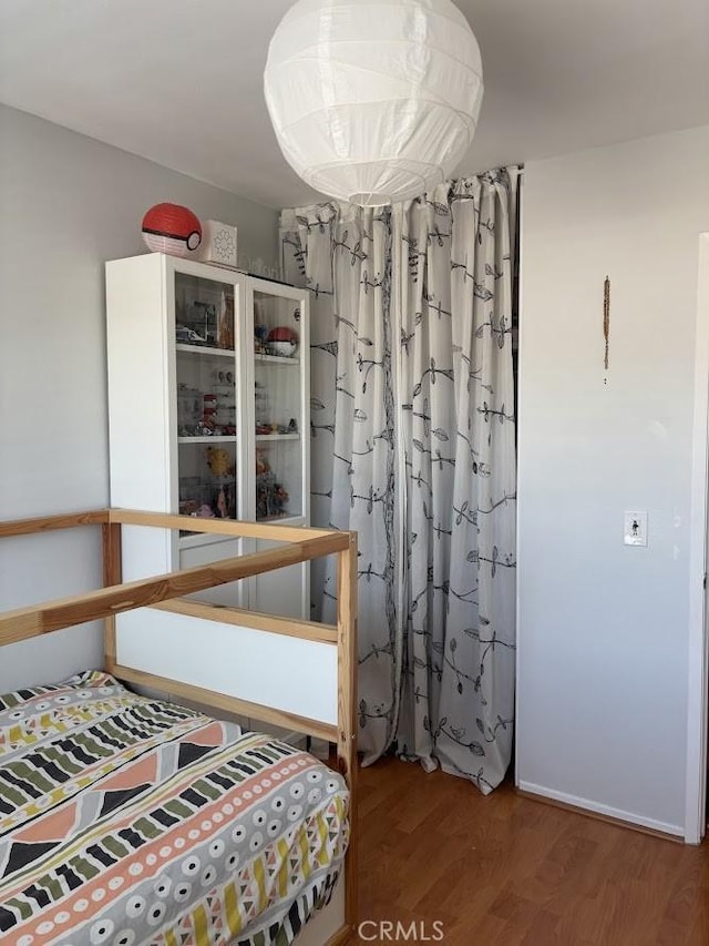 bedroom with wood-type flooring