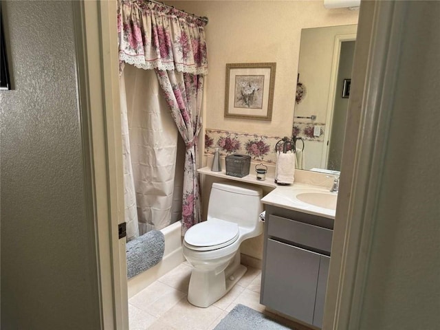 full bathroom with tile patterned floors, vanity, toilet, and shower / bath combo with shower curtain