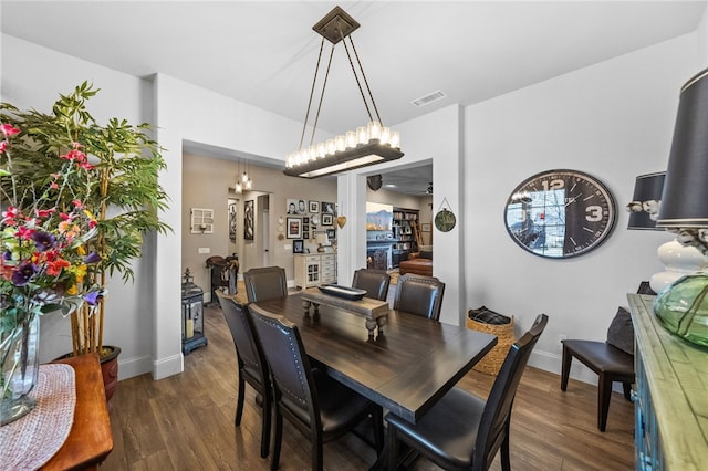 dining space with dark wood-type flooring and ceiling fan