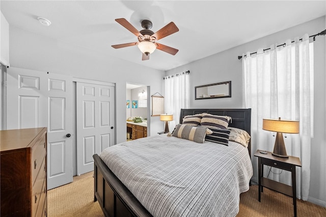 carpeted bedroom featuring ceiling fan, connected bathroom, and a closet