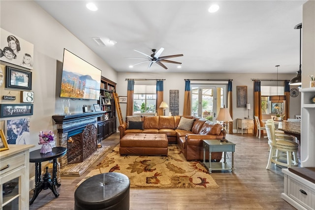 living room featuring ceiling fan and wood-type flooring