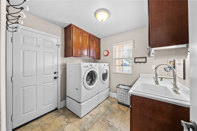 laundry room with cabinets, sink, and washing machine and dryer