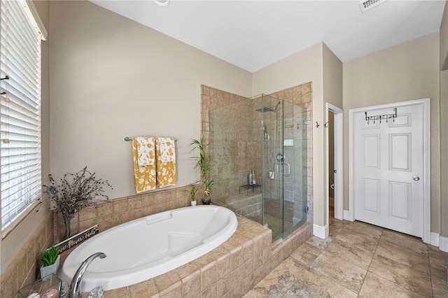 bathroom with separate shower and tub