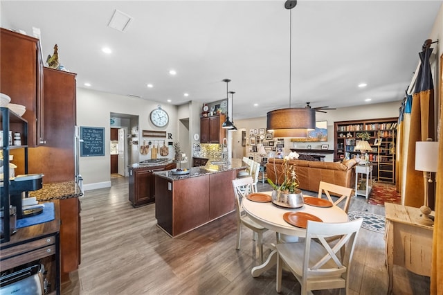 dining area with hardwood / wood-style flooring and ceiling fan