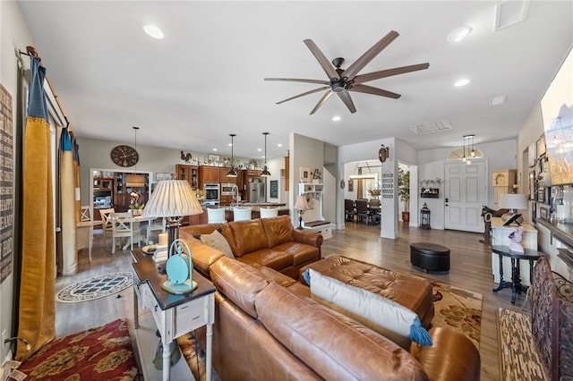 living room featuring hardwood / wood-style flooring and ceiling fan